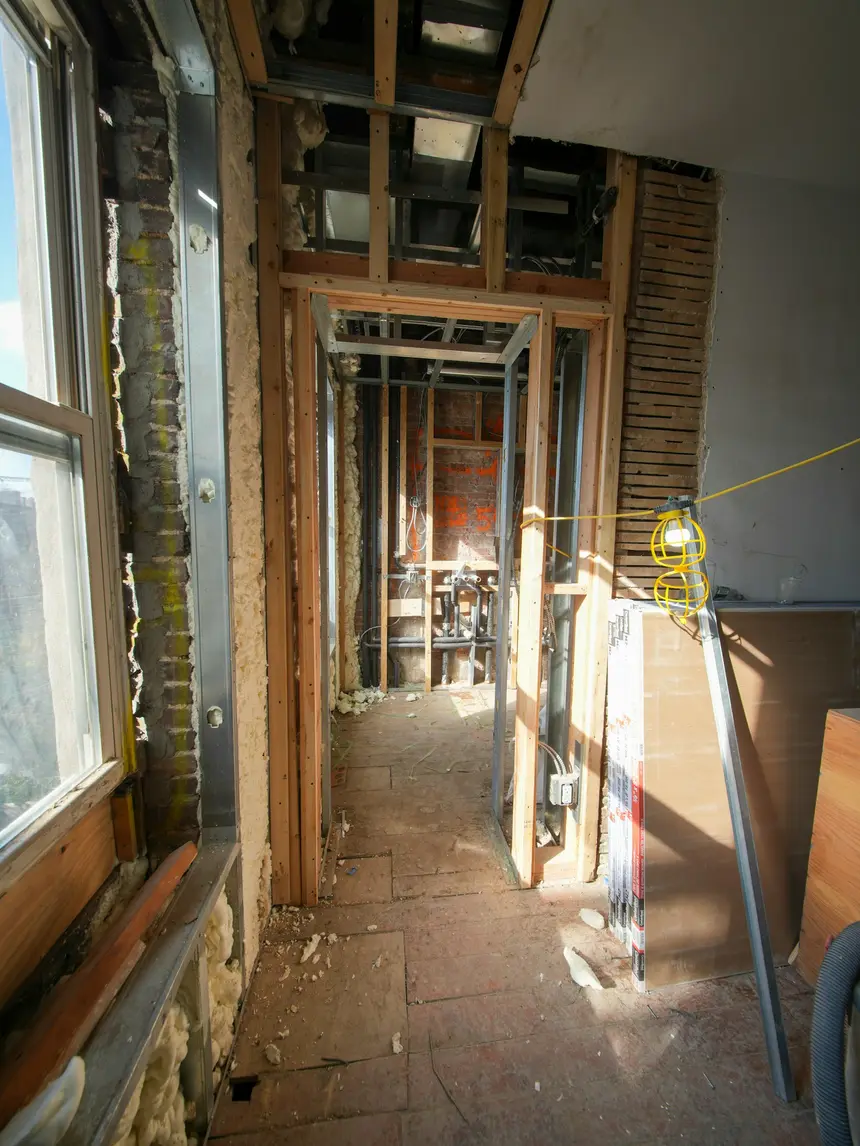 A basement stripped back to brick with new framing during a renovation