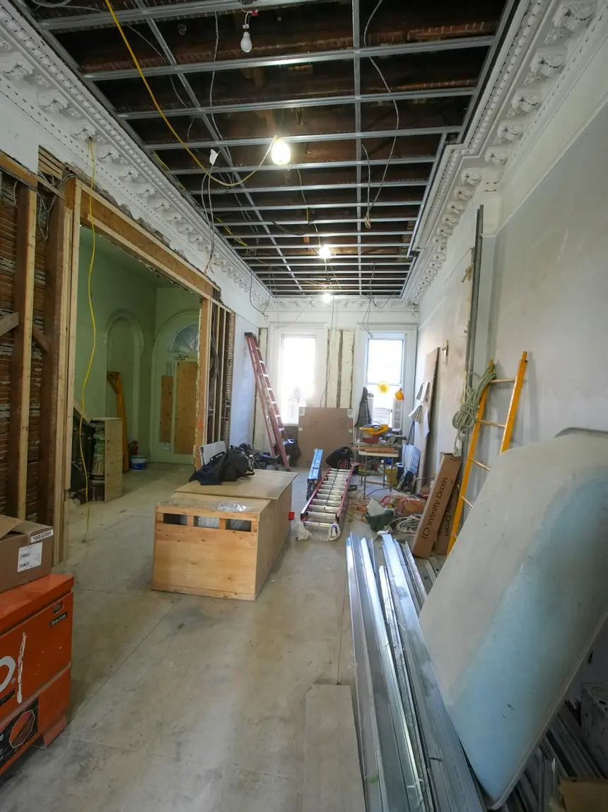 An interior renovation with the ceiling opened up and materials staged on the floor